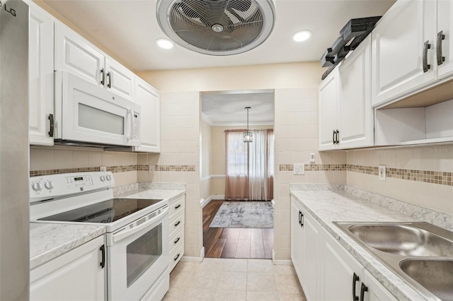 1515 12th Ct SE Unit 55, Largo, FL 33771 - kitchen featuring white appliances, light countertops, white cabinetry, backsplash, and recessed lighting