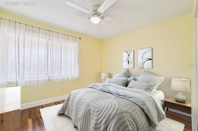 1515 12th Ct SE Unit 55, Largo, FL 33771 - bedroom with wood finished floors, baseboards, a textured ceiling, and ceiling fan