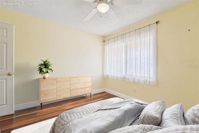1515 12th Ct SE Unit 55, Largo, FL 33771 - bedroom with dark wood-type flooring, baseboards, and a textured ceiling