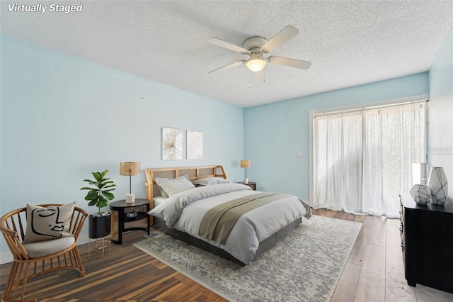 1515 12th Ct SE Unit 55, Largo, FL 33771 - bedroom featuring a textured ceiling, wood finished floors, and ceiling fan