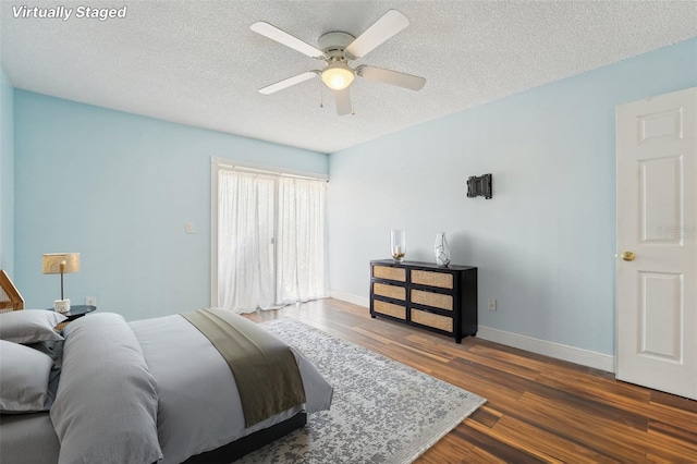 1515 12th Ct SE Unit 55, Largo, FL 33771 - bedroom with wood finished floors, a textured ceiling, baseboards, and ceiling fan