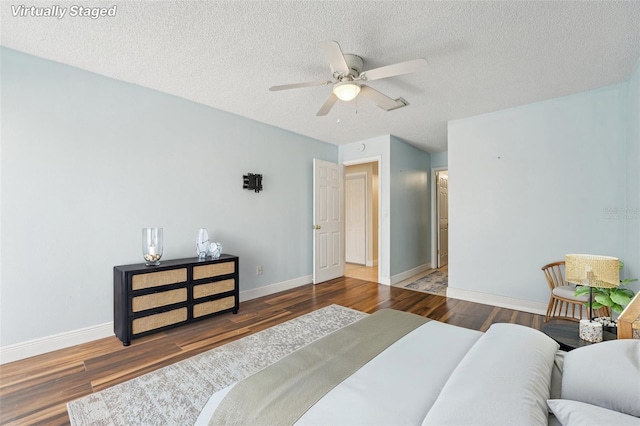 1515 12th Ct SE Unit 55, Largo, FL 33771 - bedroom with wood finished floors, baseboards, a textured ceiling, and ceiling fan
