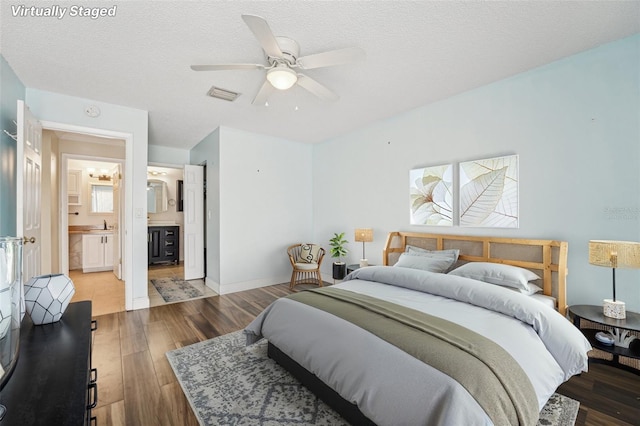 1515 12th Ct SE Unit 55, Largo, FL 33771 - bedroom featuring wood finished floors, ensuite bath, ceiling fan, a textured ceiling, and baseboards