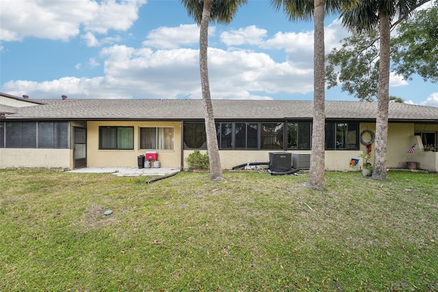 1515 12th Ct SE Unit 55, Largo, FL 33771 - rear view of house with a sunroom, a lawn, and roof with shingles