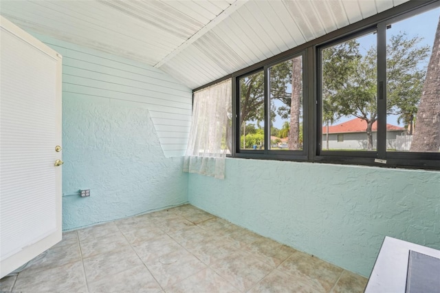 1515 12th Ct SE Unit 55, Largo, FL 33771 - unfurnished sunroom featuring a textured wall and vaulted ceiling