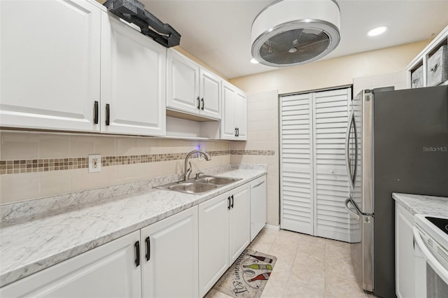 1515 12th Ct SE Unit 55, Largo, FL 33771 - kitchen featuring white cabinets, white appliances, light tile patterned floors, tasteful backsplash, and recessed lighting