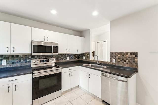 926 SW 37th St, Cape Coral, FL 33914 - kitchen featuring a sink, backsplash, dark countertops, and stainless steel appliances