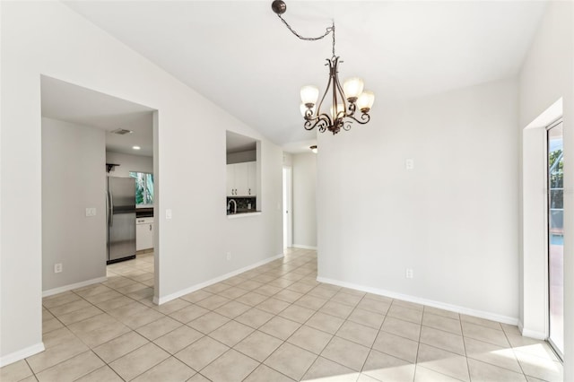 926 SW 37th St, Cape Coral, FL 33914 - spare room featuring baseboards, light tile patterned flooring, a notable chandelier, and vaulted ceiling