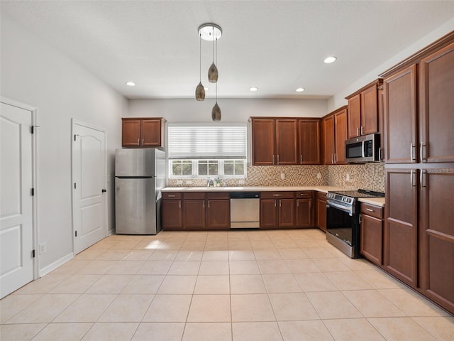 kitchen with recessed lighting, light countertops, a sink, backsplash, and stainless steel appliances