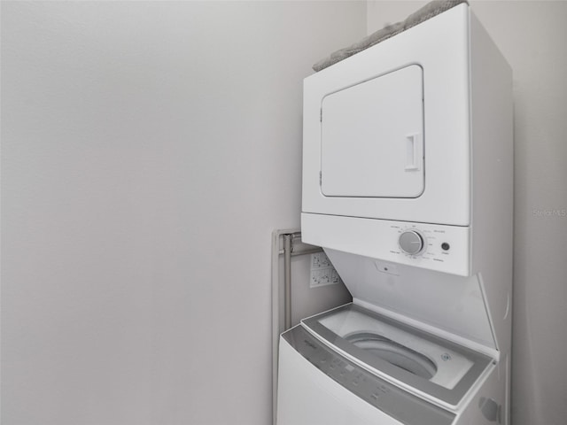 washroom featuring stacked washer / dryer