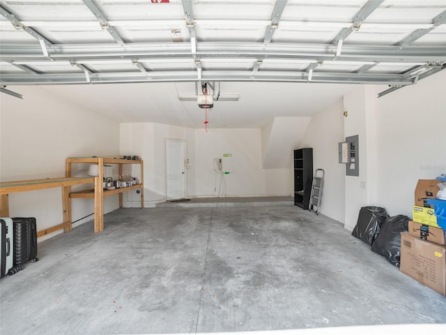 garage with a garage door opener and electric panel
