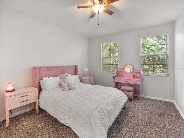 carpeted bedroom featuring baseboards, ceiling fan, and multiple windows
