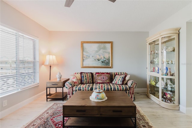 2457 Ecuadorian Way Unit 63, Clearwater, FL 33763 - living area with light wood-style flooring, ceiling fan, and a healthy amount of sunlight