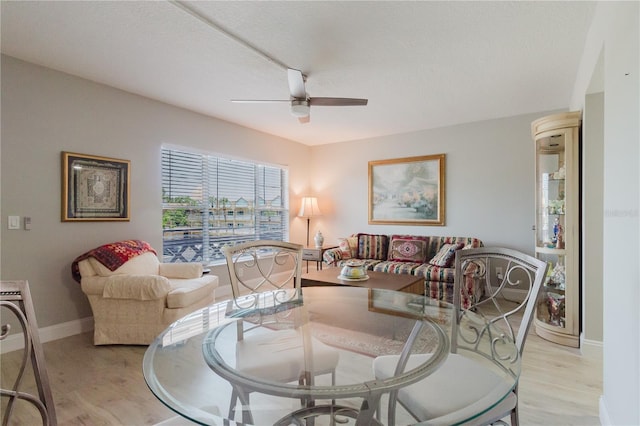 2457 Ecuadorian Way Unit 63, Clearwater, FL 33763 - dining room featuring baseboards, ceiling fan, and light wood finished floors