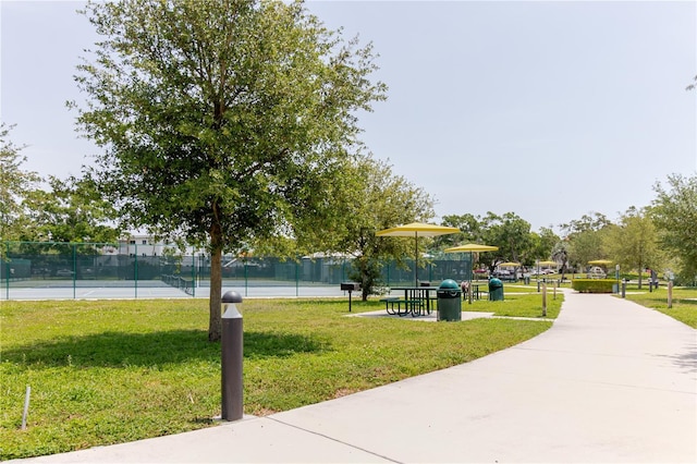 2457 Ecuadorian Way Unit 63, Clearwater, FL 33763 - view of property's community with a lawn, fence, and a tennis court