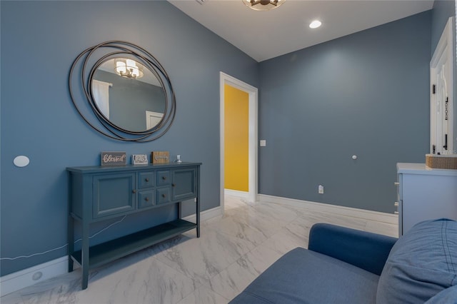 sitting room featuring recessed lighting, marble finish floor, and baseboards