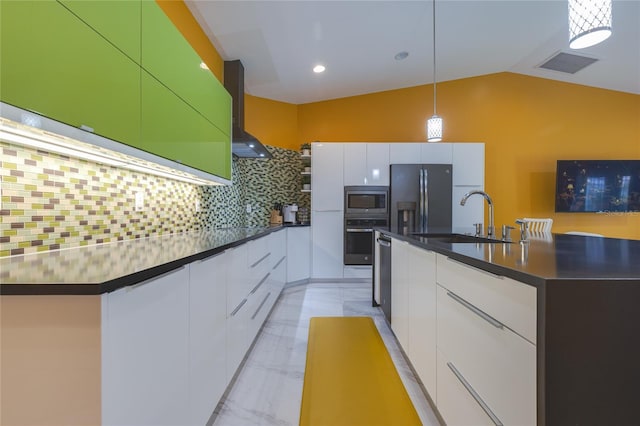 kitchen with modern cabinets, a sink, appliances with stainless steel finishes, and wall chimney range hood