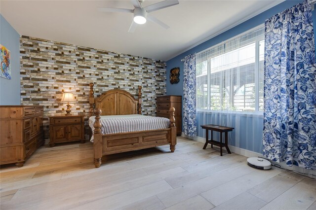 bedroom with ceiling fan and light wood-type flooring