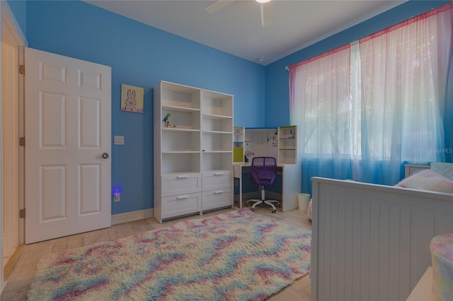 bedroom with wood finished floors and a ceiling fan