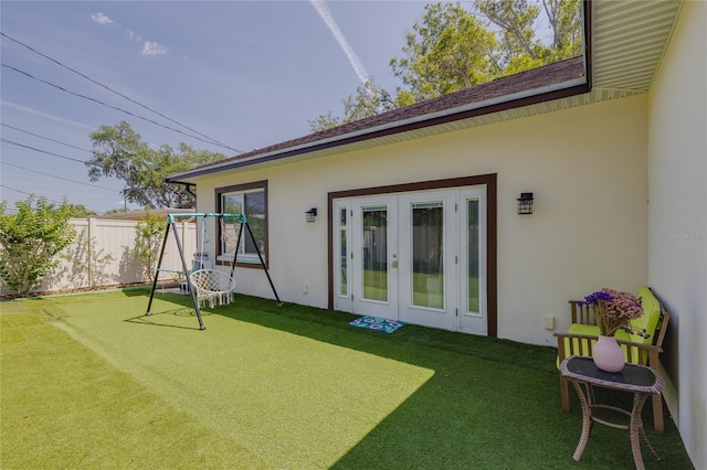 back of property featuring stucco siding, french doors, and fence