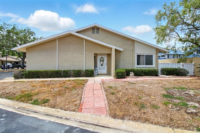 1671 Cape Ann Ave NE Unit 4, Saint Petersburg, FL 33702 - ranch-style house with brick siding and fence