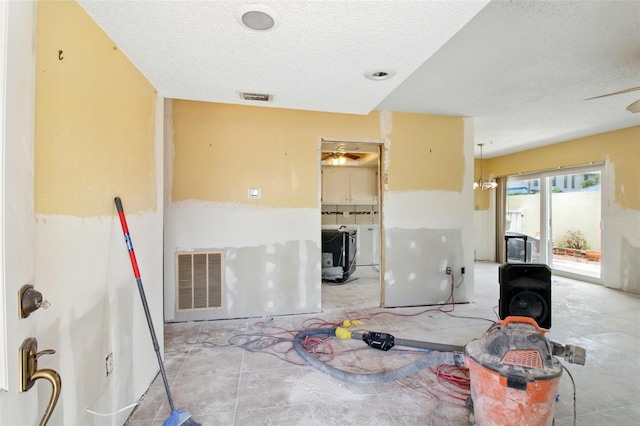 1671 Cape Ann Ave NE Unit 4, Saint Petersburg, FL 33702 - interior space with a textured ceiling, visible vents, and separate washer and dryer