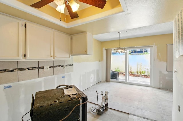1671 Cape Ann Ave NE Unit 4, Saint Petersburg, FL 33702 - kitchen featuring light tile patterned floors, pendant lighting, white cabinets, a raised ceiling, and ceiling fan