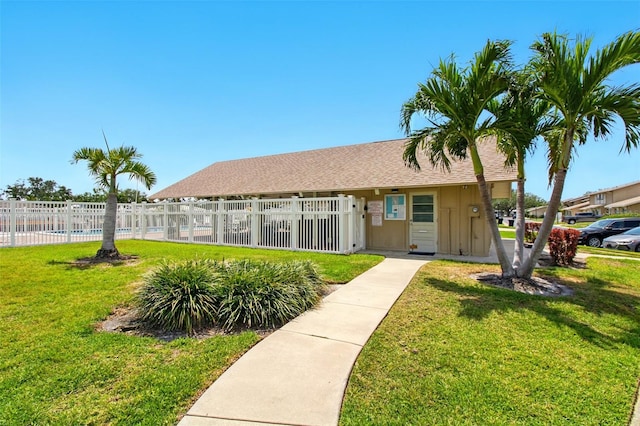 1671 Cape Ann Ave NE Unit 4, Saint Petersburg, FL 33702 - view of front of home with a front yard, a shingled roof, and fence private yard
