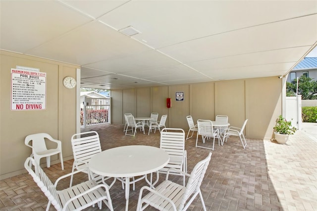1671 Cape Ann Ave NE Unit 4, Saint Petersburg, FL 33702 - view of patio with outdoor dining space and a gate