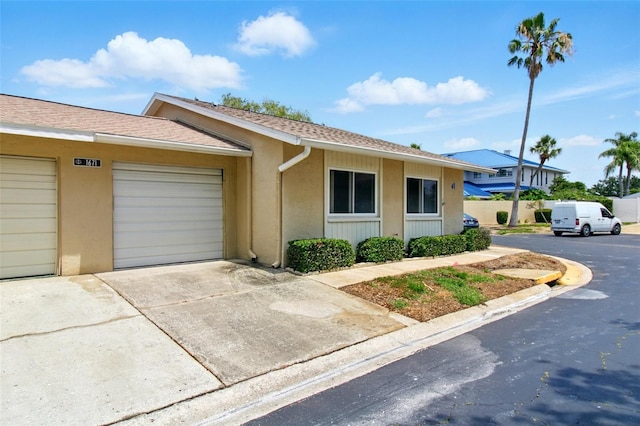 1671 Cape Ann Ave NE Unit 4, Saint Petersburg, FL 33702 - ranch-style home with an attached garage, driveway, and stucco siding