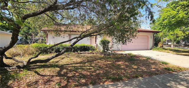 8623 Stonehedge Way, Hudson, FL 34667 - view of front of property with stucco siding, an attached garage, and driveway