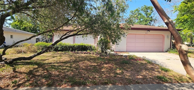 8623 Stonehedge Way, Hudson, FL 34667 - view of front of property featuring an attached garage, stucco siding, and driveway