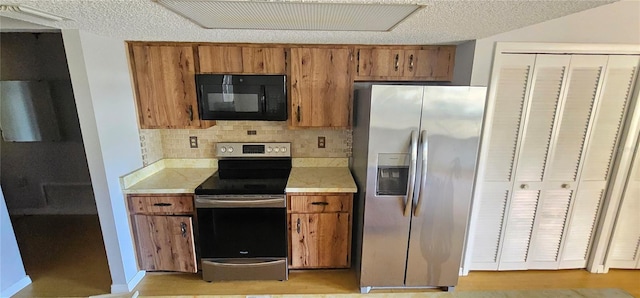 8623 Stonehedge Way, Hudson, FL 34667 - kitchen with light countertops, backsplash, appliances with stainless steel finishes, and brown cabinetry