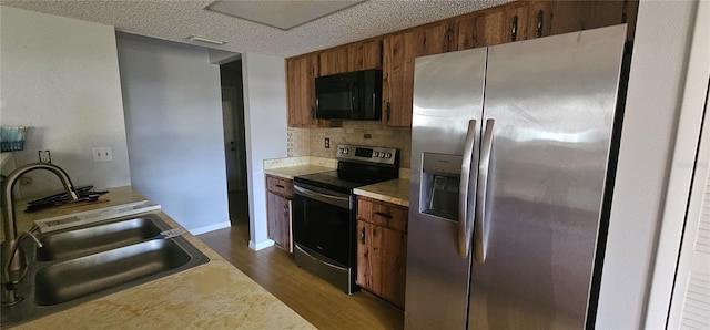 8623 Stonehedge Way, Hudson, FL 34667 - kitchen with dark wood-style flooring, appliances with stainless steel finishes, tasteful backsplash, brown cabinets, and a sink