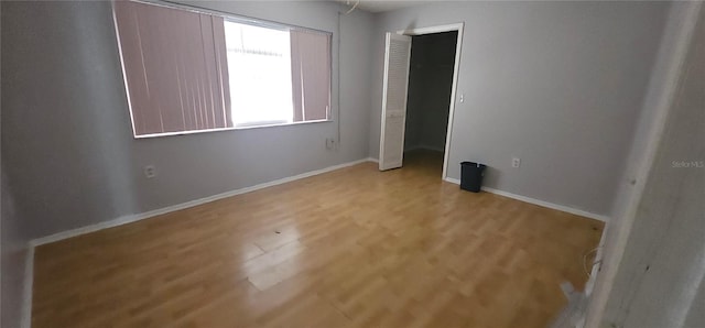 8623 Stonehedge Way, Hudson, FL 34667 - unfurnished bedroom with light wood-type flooring and baseboards