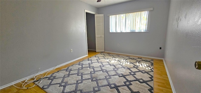 8623 Stonehedge Way, Hudson, FL 34667 - spare room with baseboards, a ceiling fan, and wood finished floors