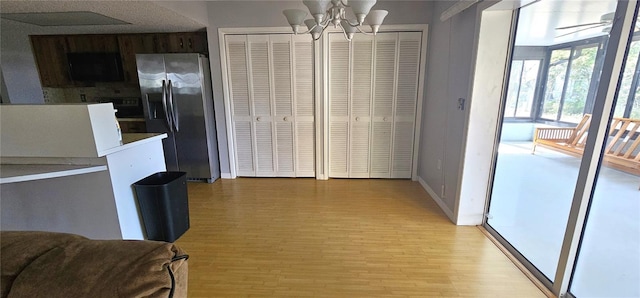 8623 Stonehedge Way, Hudson, FL 34667 - dining space with light wood-type flooring, baseboards, and ceiling fan with notable chandelier