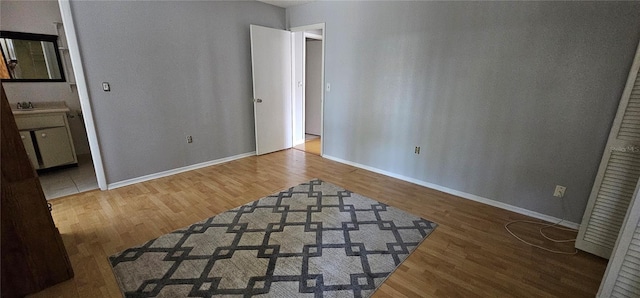 8623 Stonehedge Way, Hudson, FL 34667 - unfurnished bedroom with baseboards and wood finished floors