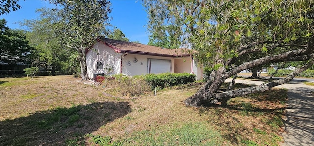8623 Stonehedge Way, Hudson, FL 34667 - view of side of property with stucco siding and a yard