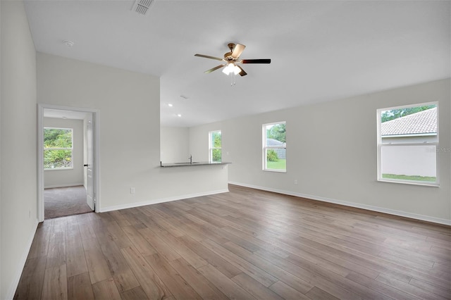 13 Prince Michael Ln, Palm Coast, FL 32164 - unfurnished living room with baseboards, visible vents, wood finished floors, and a ceiling fan