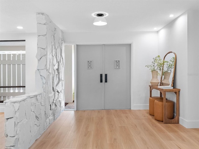 hall with recessed lighting and wood finished floors
