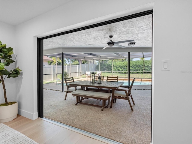 dining space with light wood-style floors, baseboards, ceiling fan, and a wealth of natural light