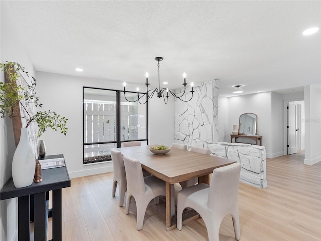 dining room featuring recessed lighting, baseboards, light wood finished floors, and a chandelier