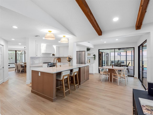 kitchen with custom exhaust hood, a large island, recessed lighting, light wood-style flooring, and stainless steel appliances