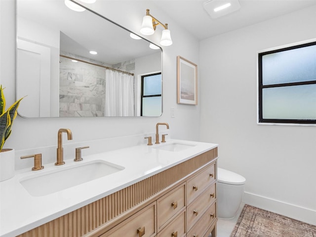 bathroom featuring a sink, curtained shower, toilet, and double vanity