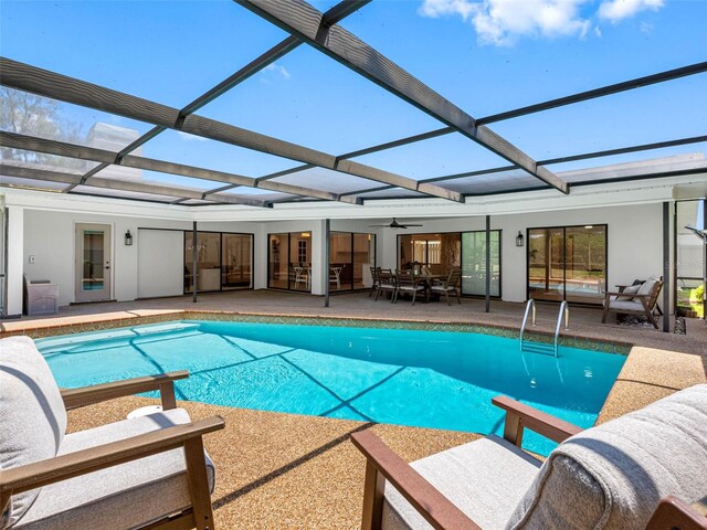 outdoor pool featuring a patio, an outdoor living space, ceiling fan, and a lanai