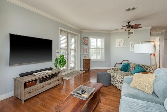 living room featuring ornamental molding, ceiling fan, wood finished floors, and visible vents