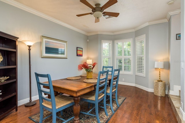 dining space with baseboards, wood finished floors, a ceiling fan, and crown molding