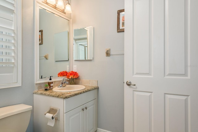 bathroom featuring toilet and vanity