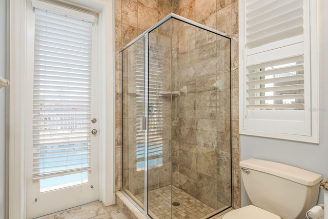 full bath with toilet and a shower stall